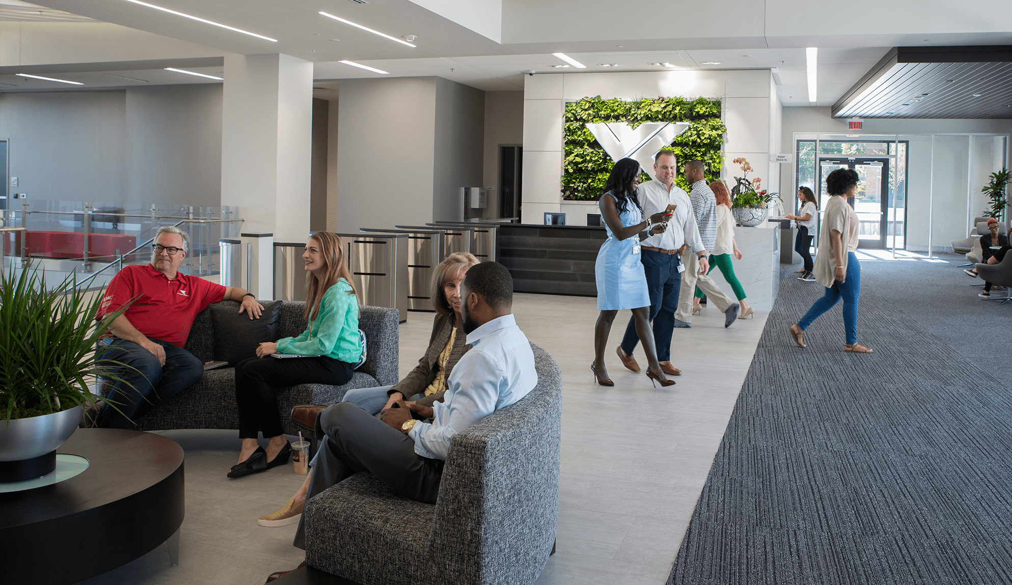 Open office lobby with people sitting and walking.