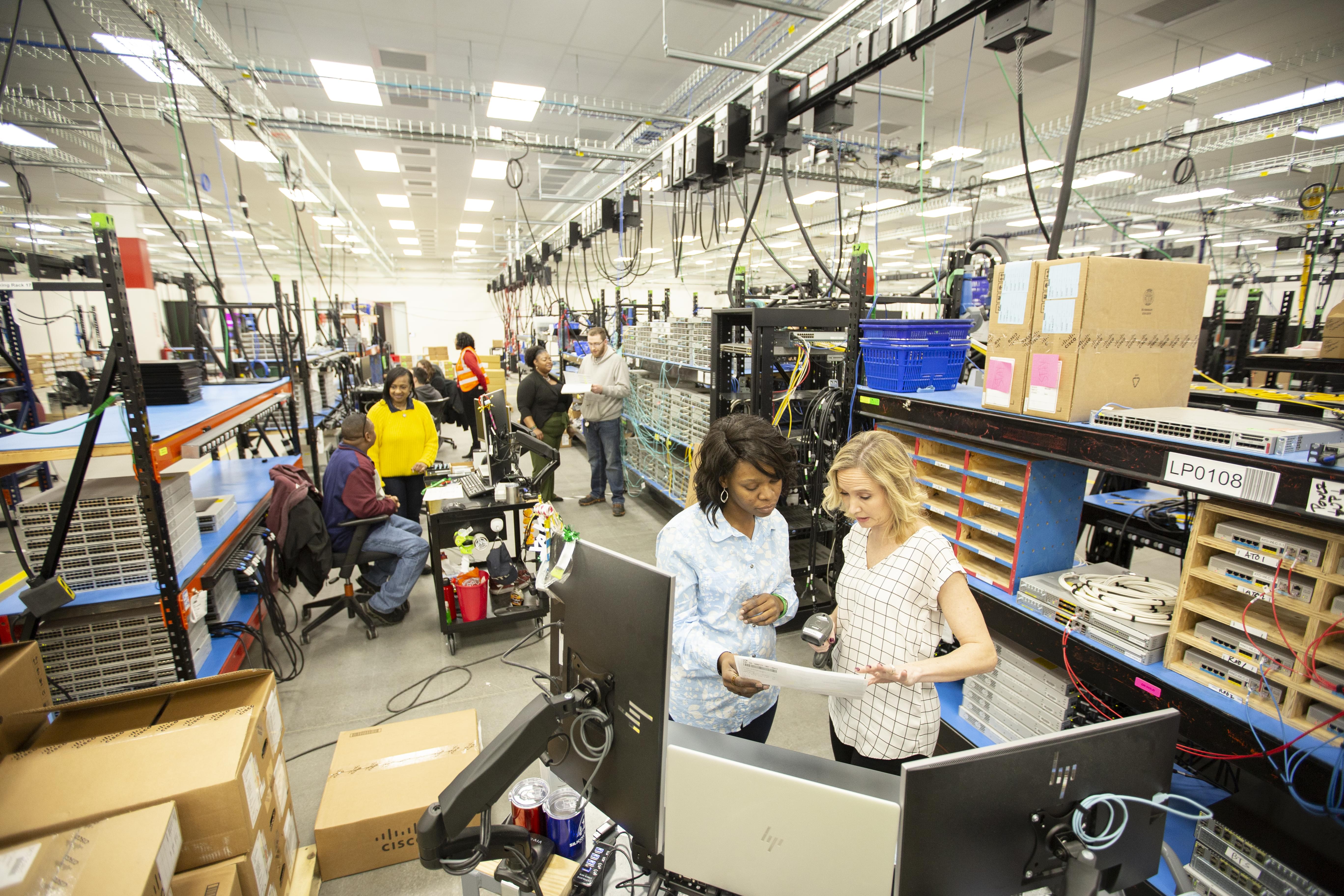 Workers collaborating in the North American Integration Center facility.