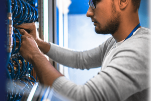 Technician working on server racks in a data center.