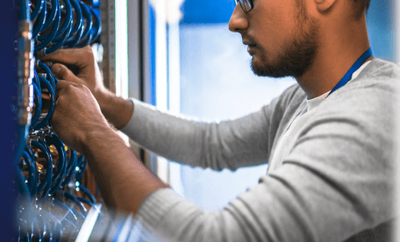 Technician working on server racks in a data center.